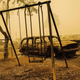 A charred swing set and car are seen after the passage of the Santiam Fire in Gates, Oregon, on September 10, 2020.